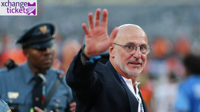 Spain national football team head coach Luis de la Fuente waving hand towards fans in stadium.